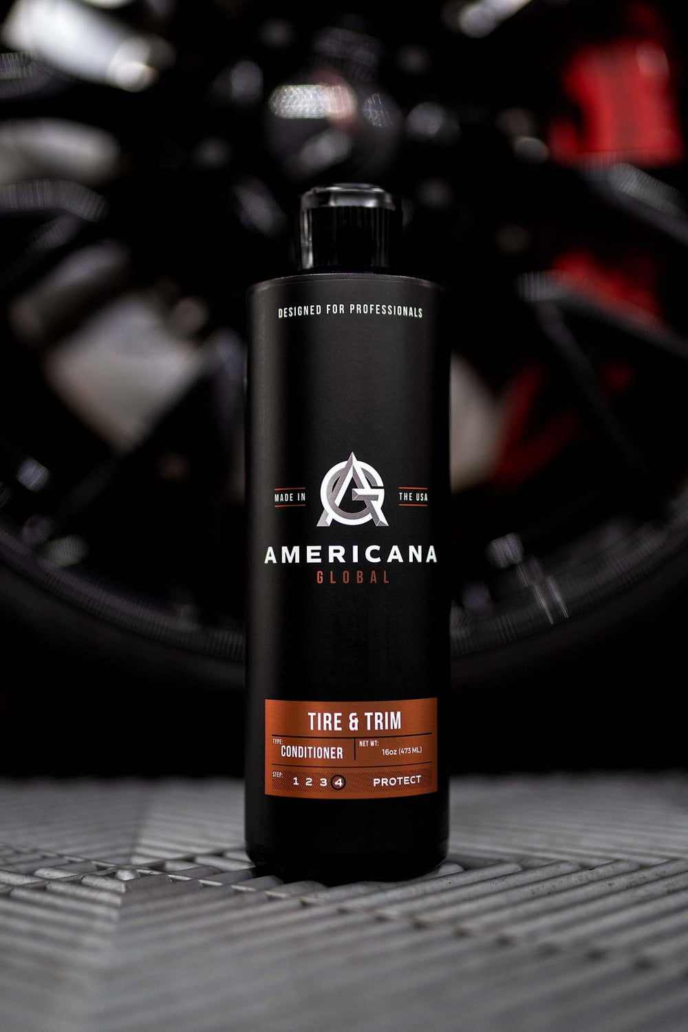 Americana Global tire and trim product in front of a vehicle wheel