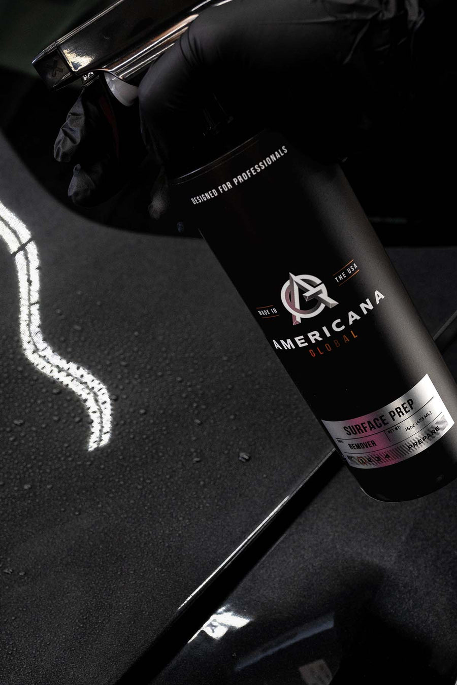 Americana Global prep product held over a black vehicle