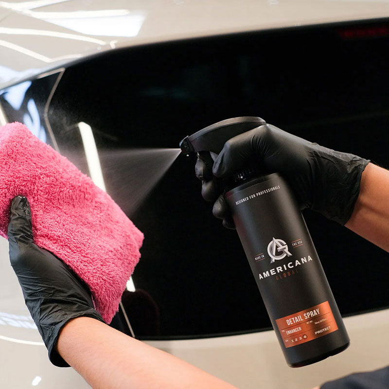 Americana Global Detail Spray applied to a black car with a pink microfiber towel