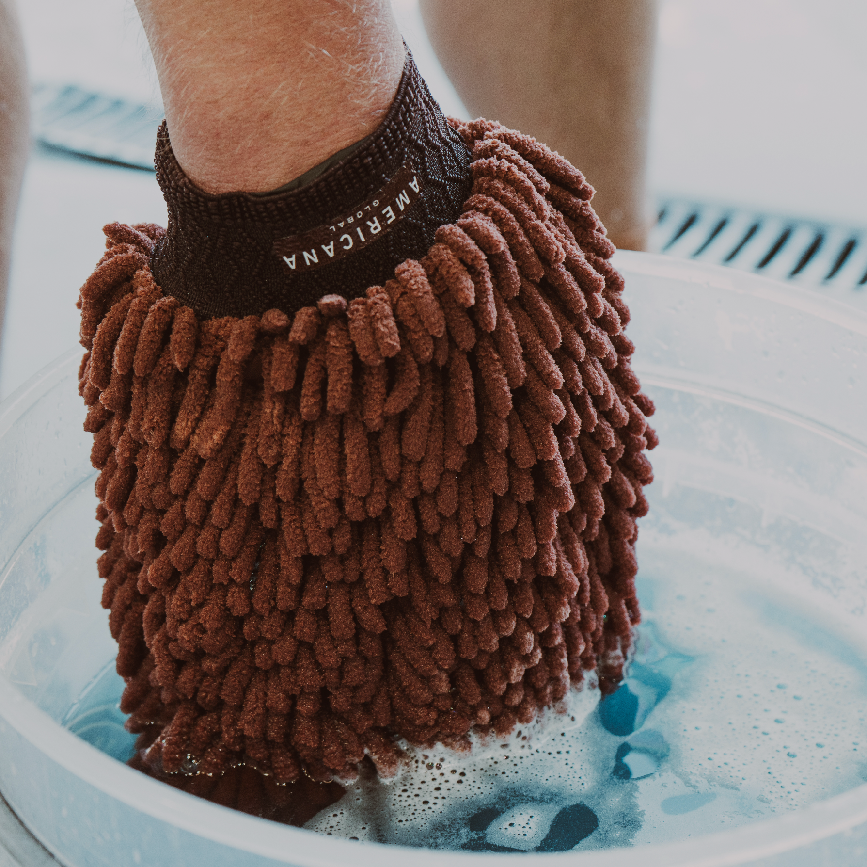 Americana Global microfiber wash mitt in a car wash bucket