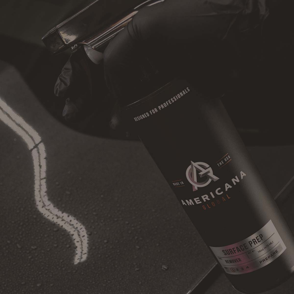 Americana Global Surface Prep bottle held over a vehicle panel
